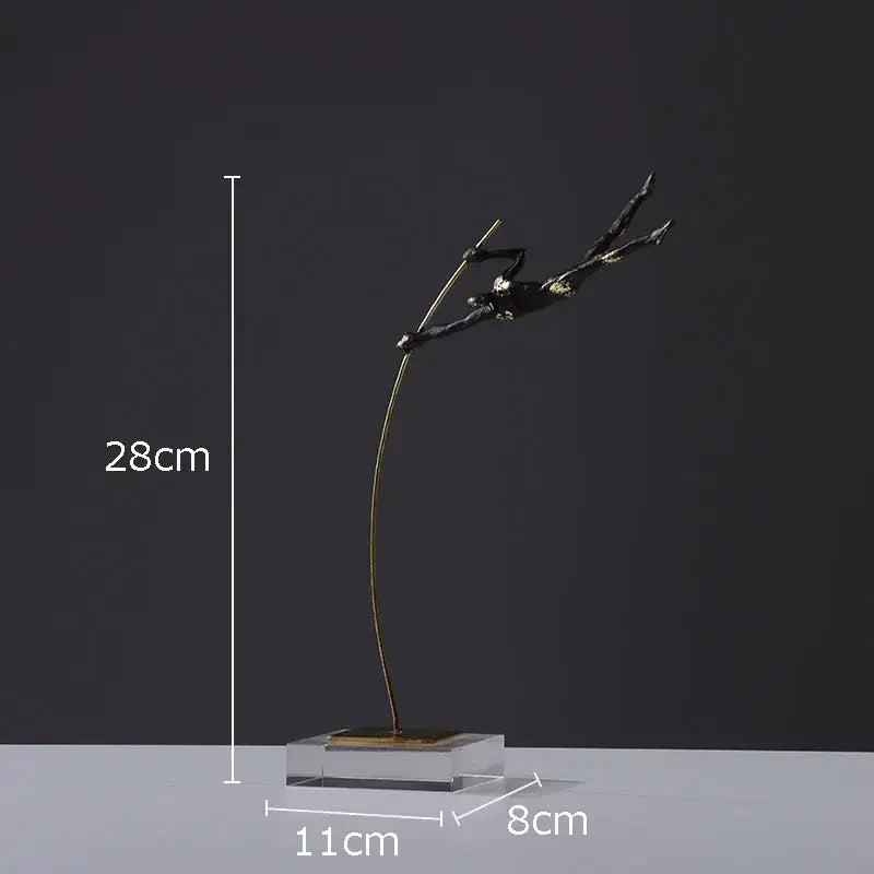 A sleek black and gold gymnastic acrobat resin sculpture on a clear acrylic base for living room decor by decorbites