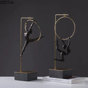 Black gold gymnastic acrobat resin sculpture with two black metal figurines in gold hoops on dark stone bases decorbites gymnastic acrobat