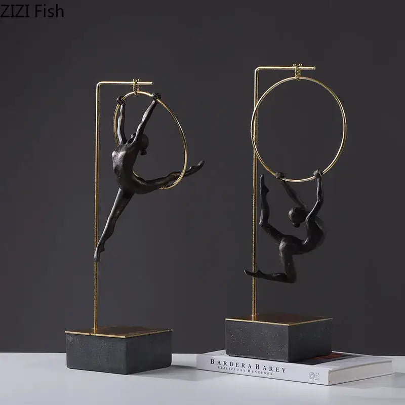 Black gold gymnastic acrobat resin sculpture with two black metal figurines in gold hoops on dark stone bases decorbites gymnastic acrobat