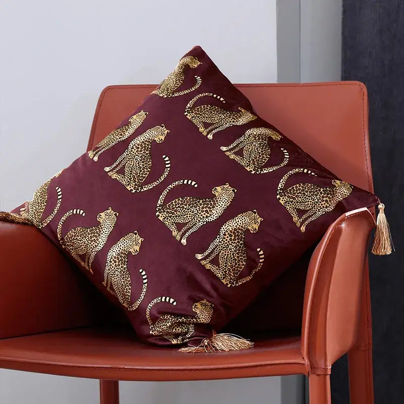 Maroon velvet throw pillow cover with gold leopard print and matching tassels for living room decor