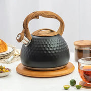 Black hammered stainless steel whistle boiling kettle with wooden handle and silver spout for kitchen decor