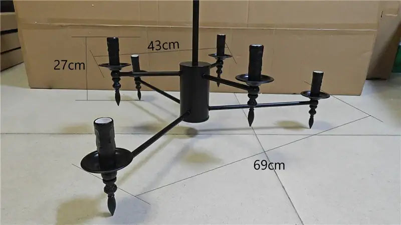 Black iron art candle chandelier pendant light with six candle-style arms and decorative finials for living room decorbites