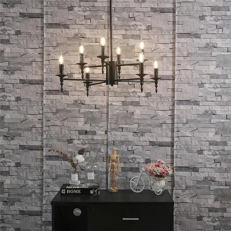 Black iron art candle chandelier pendant light featuring multiple lit candle-like bulbs for living room decorbites iron art
