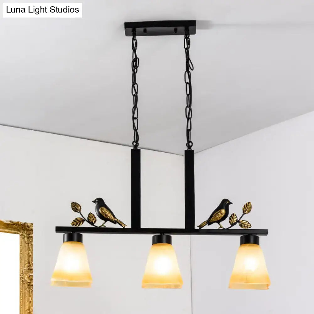 DecorBites black light pendant with gold bird and leaf accents and three warm tan glass shades for dining room island lighting