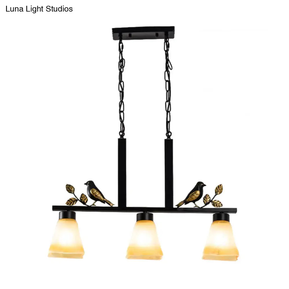 DecorBites black island light pendant with ornate bird and leaf accents and three tan glass shades for dining room
