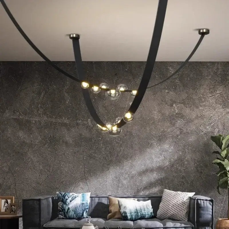 Black metal pendant light with curved arms and clear glass globe light sources as a dining room focal point