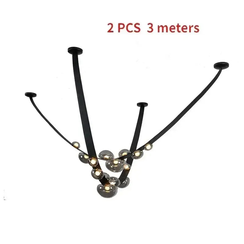 Black metal pendant light with curved arms and spherical glass globe light sources as dining room focal point