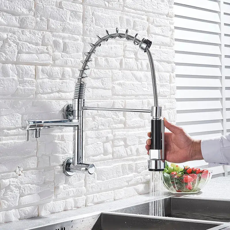 Chrome-finished decorbites dual spout kitchen faucet with flexible coiled hose and black accent spray head front view