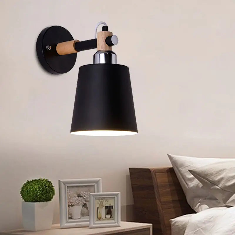 Black matte wall lamp with empire shade, wooden arm, and chrome hardware designed as a 12-inch fixture for stairs