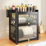 Black mesh double layer dish drying rack with drawers and top shelf holding spice jars and utensils for kitchen storage
