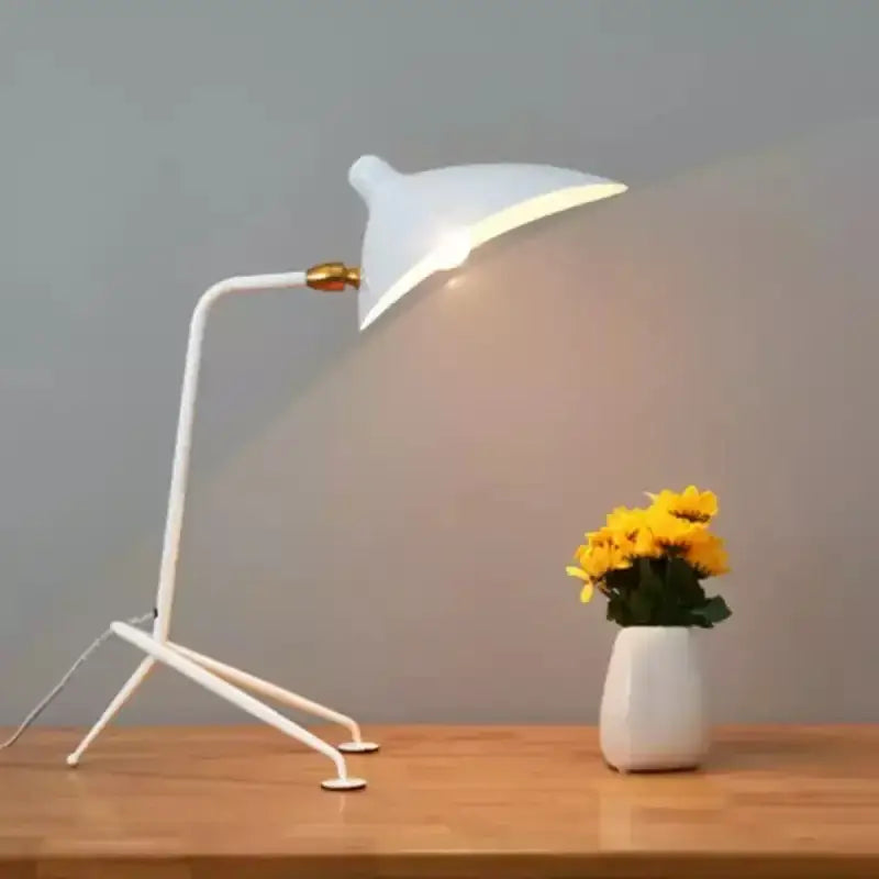 Black metal 3-arm floor lamp with white minimalist desk lamp featuring a sleek curved arm and gold-toned joint decorbites adjustable arm