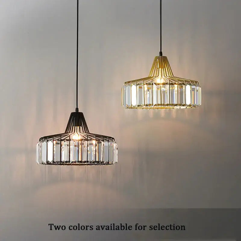 Two modern black metal crystal kitchen pendant lamps with geometric wire frames and clear prisms by decorbites