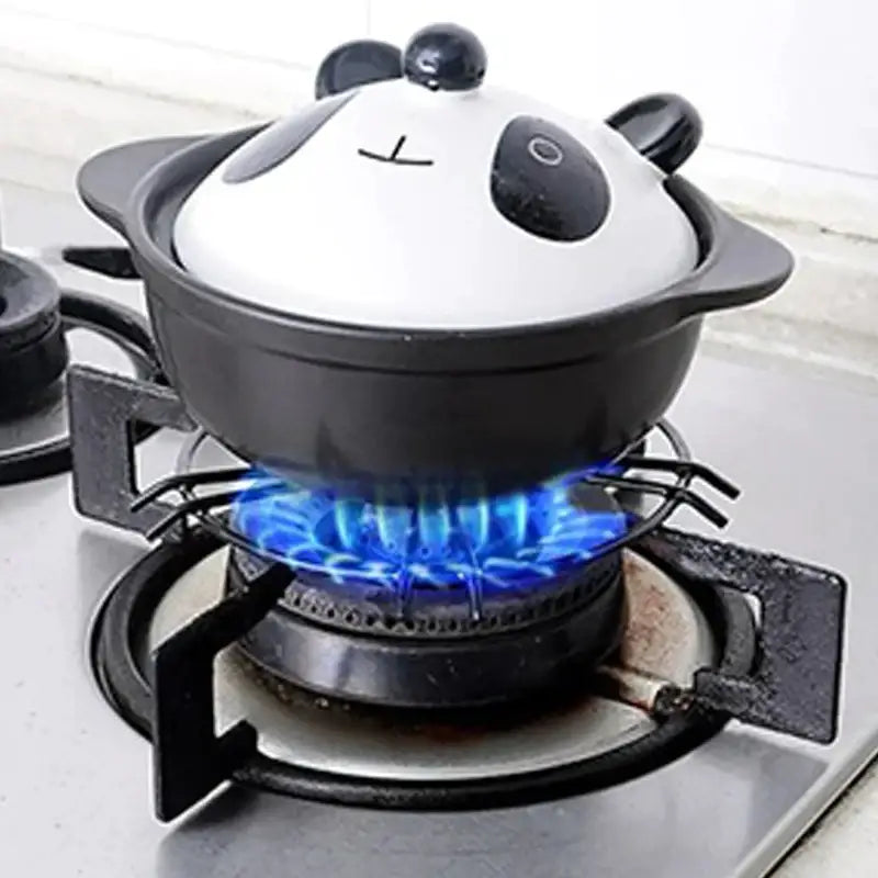 Black and white ceramic pot with panda face lid shown on a black metal gas stove pot holder kitchen burner rack decorbites gas stove