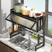 Black metal kitchen cabinet organizer shelf with slanted textured glass panel and multiple compartments for utensils and cookware