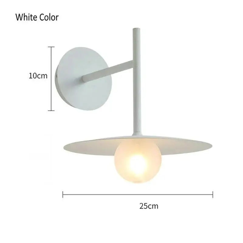 White minimalist wall lamp with sleek circular base and glass ball shade for modern decorbites glass ball bedroom sconce