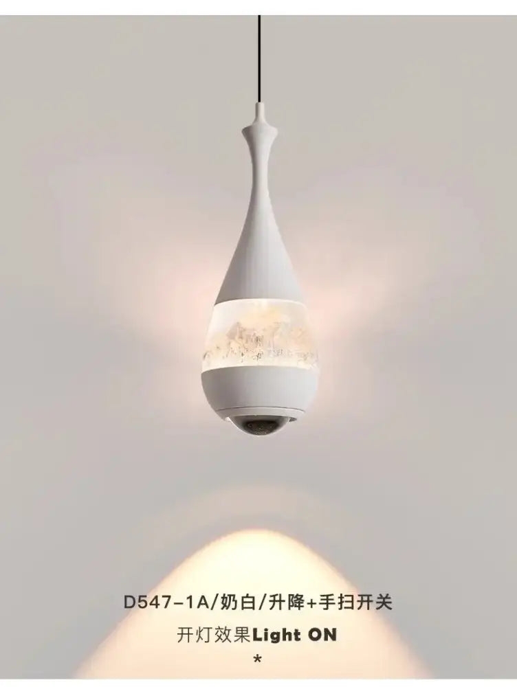 A sleek white teardrop glass pendant chandelier with delicate patterns for dining room decor lighting