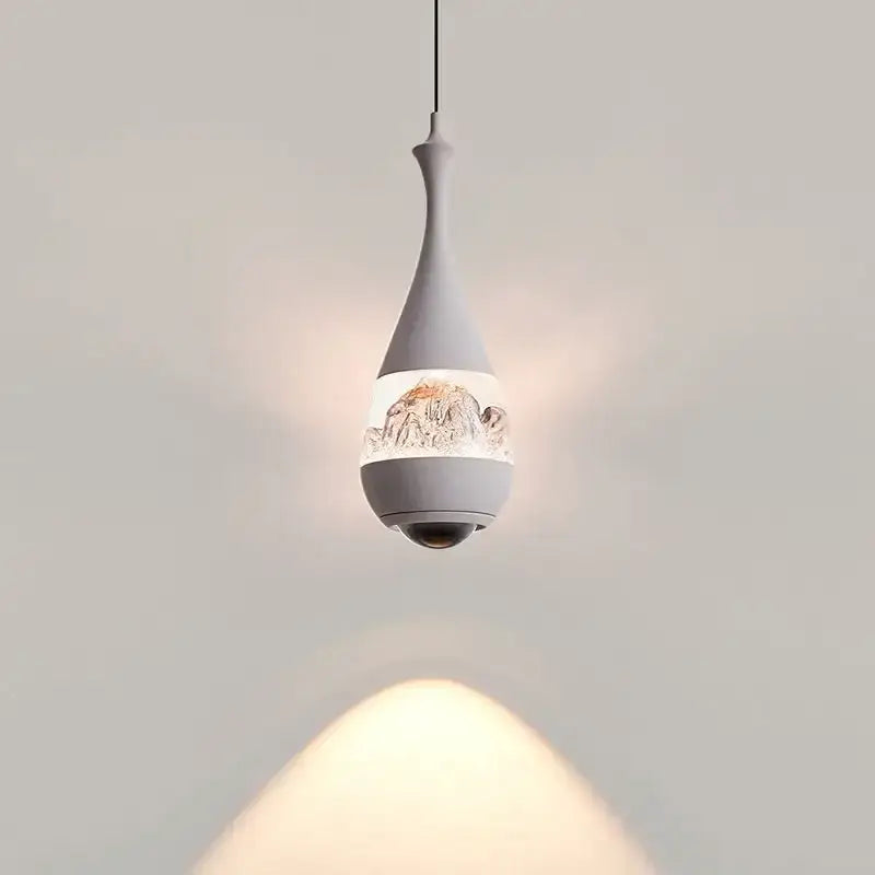 Black mountain glass pendant chandelier with matte gray teardrop design and illuminated mountain artwork for dining room decor