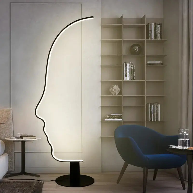 A sleek black nordic human floor lamp with glowing led light tracing a profile silhouette for living room decorbites