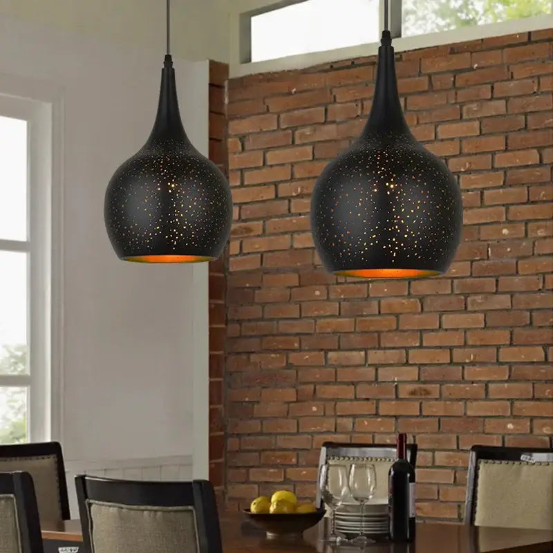 Black nordic industrial pendant light with speckled textured surface and warm orange glow for dining room decorbites black nordic