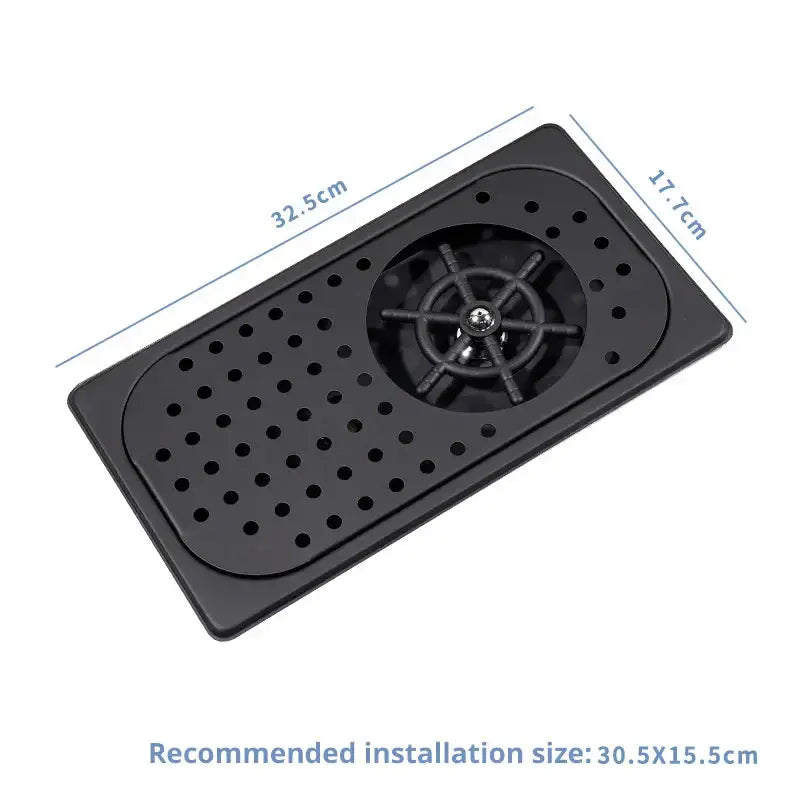 Black plastic glass rinser faucet sink drain tray with central circular grate and perforations for kitchen use