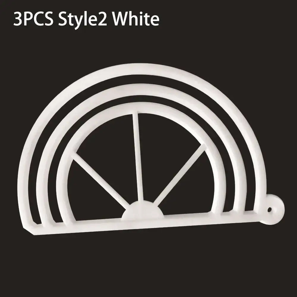 White plastic cookie cutter shaped like half circle with spokes designed for circular cookies alongside black decorbites hat brim bender