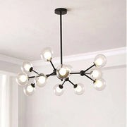 Black postmodern sputnik chandelier with black metal frame and clear glass globe bulbs for dining room decorbites black postmodern