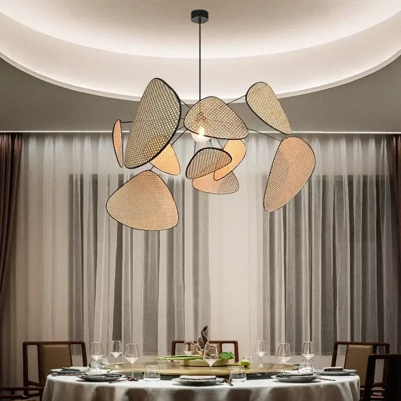 Modern decorbites black rattan ceiling chandelier with irregular woven beige rattan shades and black metal arms for dining room