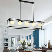 Black metal rectangle island pendant light kit with five opal glass globes and crystal accents for dining room use