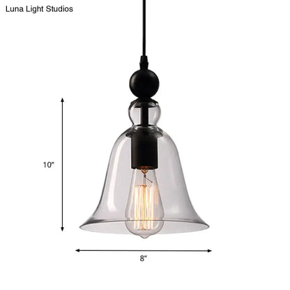Clear glass bell-shaped pendant lamp with black metal fixture and exposed edison bulb in aldhibah black rustic style