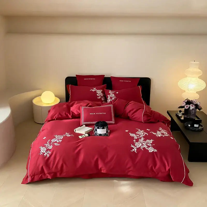 Red satin bedding set with white egyptian cotton flowers embroidery and piping for a luxurious bedroom look