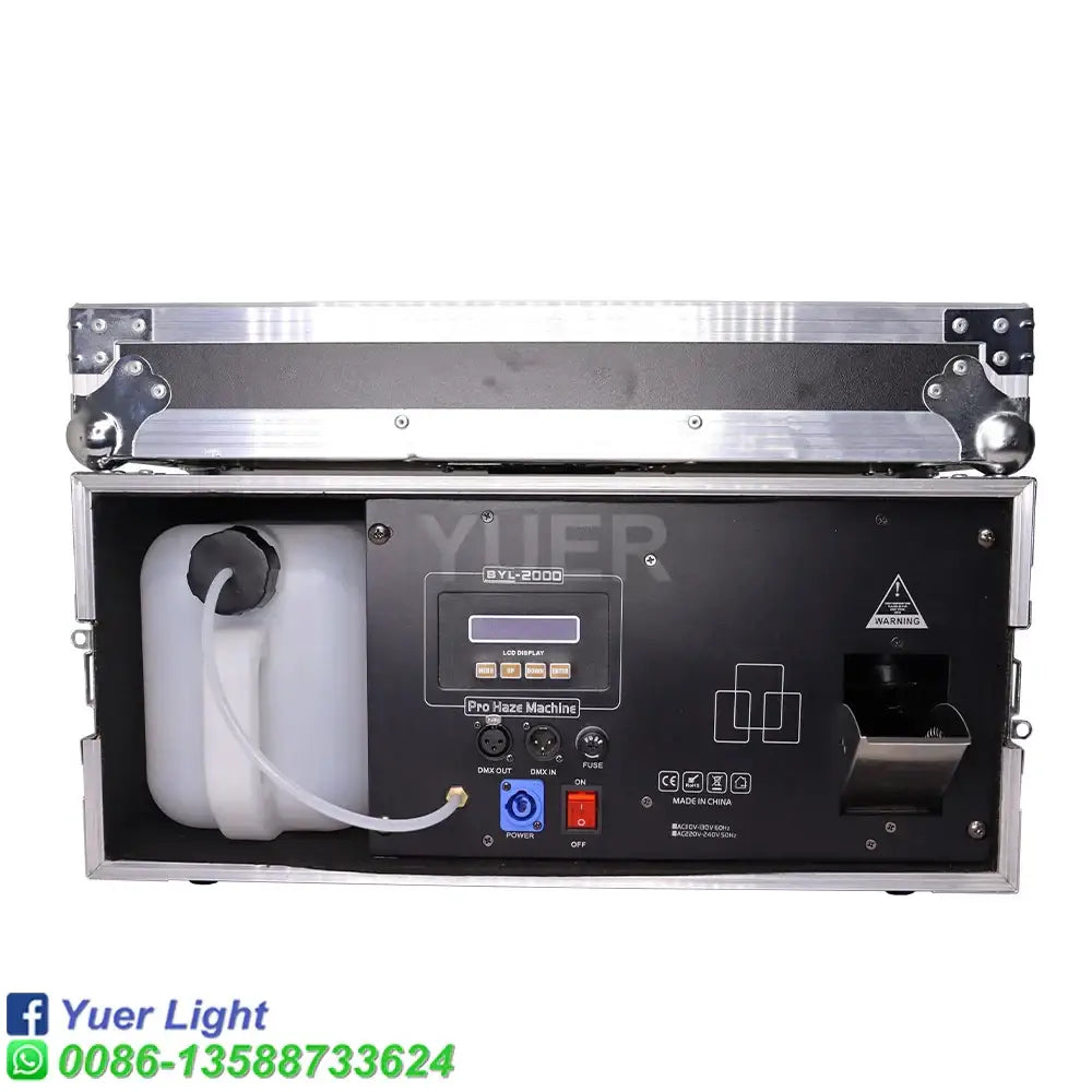 Black and silver 2000w haze machine with silver metal casing and white liquid reservoir for party room atmosphere effect