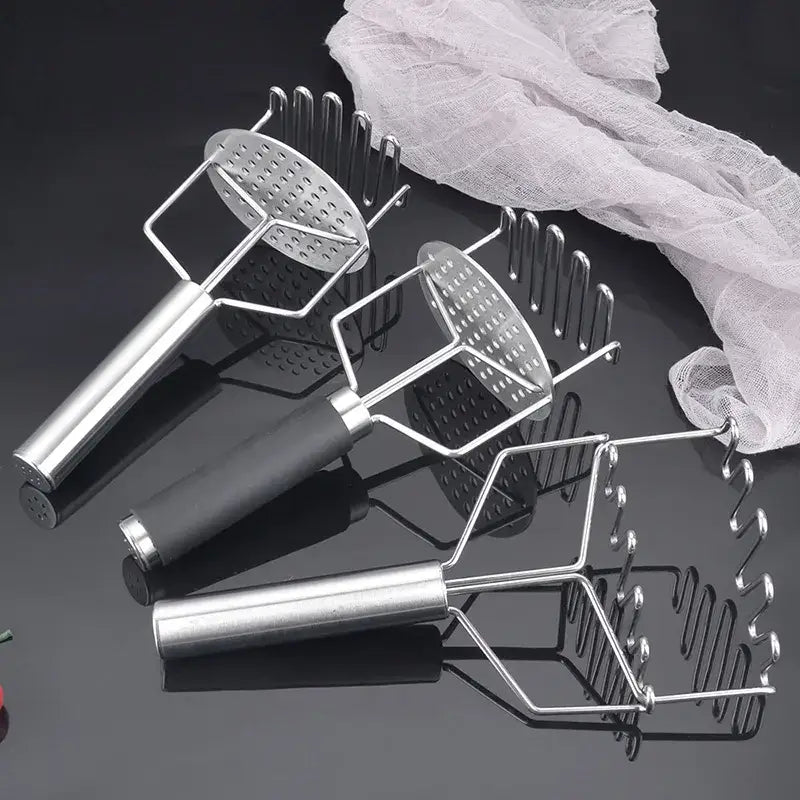 Three black and silver stainless steel potato mashers with perforated heads for varied kitchen food crushing textures