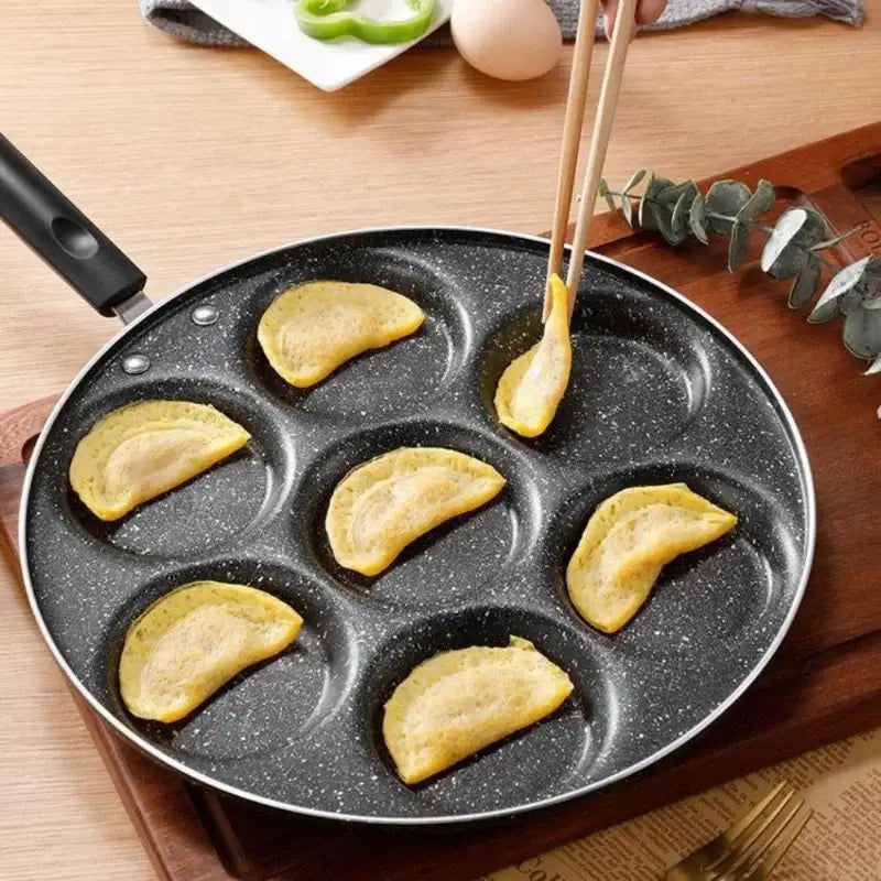 Black speckled non-stick breakfast egg pan with seven circular holes for pancakes by decorbites breakfast egg