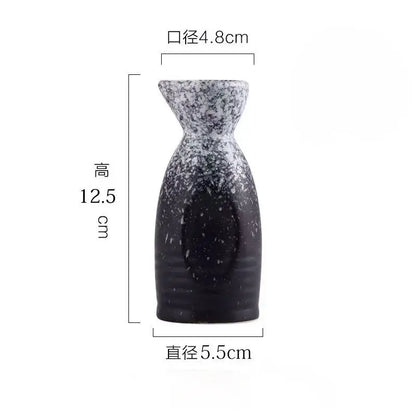A sleek black speckled ceramic wine sake bottle with tapered neck from decorbites ceramic wine sake set for dining room