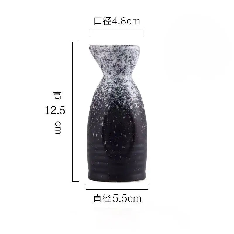 A sleek black speckled ceramic wine sake bottle with tapered neck from decorbites ceramic wine sake set for dining room