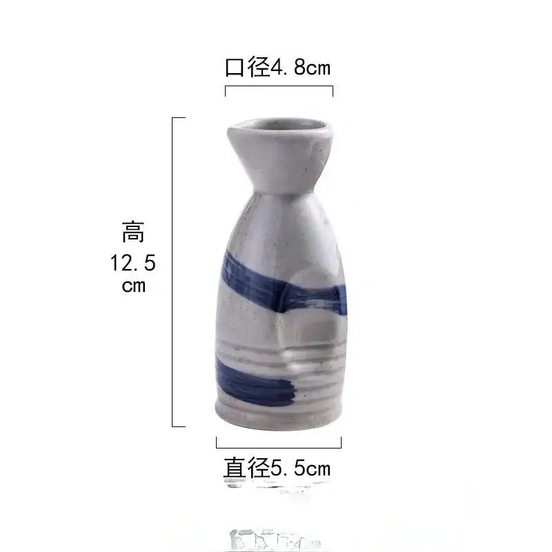 A small white ceramic wine sake bottle with bold blue brushstrokes from decorbites ceramic wine sake set