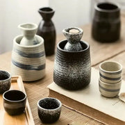 Black speckled ceramic wine sake set with heater featuring a cork-stoppered bottle nestled in its base decorbites ceramic wine