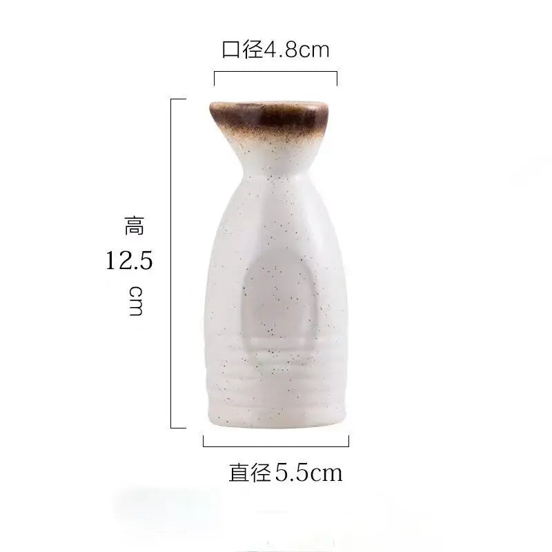 A white ceramic wine sake bottle with speckled texture and brown rim from decorbites ceramic wine sake set