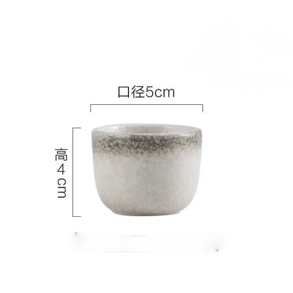 A small handcrafted ceramic wine sake cup with speckled gray white glaze from decorbites wine sake set