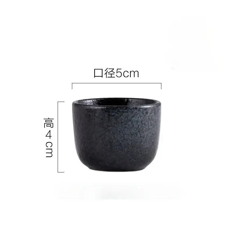 A matte black ceramic wine sake cup with speckled texture and flared rim from decorbites ceramic wine set