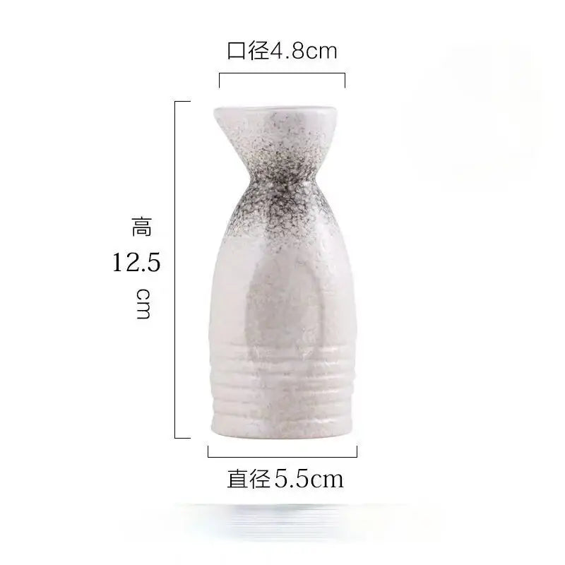 A white ceramic wine sake bottle with speckled gray pattern and ribbed texture from decorbites ceramic wine set