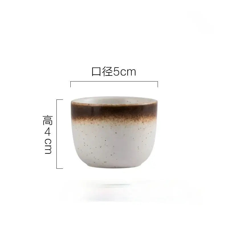 A ceramic wine sake cup with a speckled white body and brown rim from decorbites ceramic wine set for dining room use
