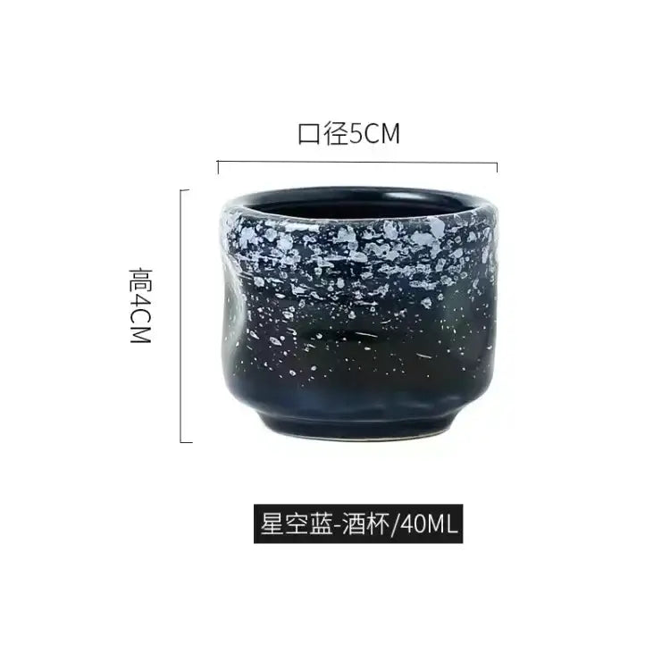 A dark blue ceramic wine sake tumbler with speckled starry glaze from decorbites ceramic wine set for dining room use