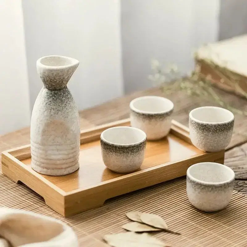 Black speckled ceramic wine sake set with heater featuring tall bottle and cups on wooden tray for dining room decorbites ceramic wine
