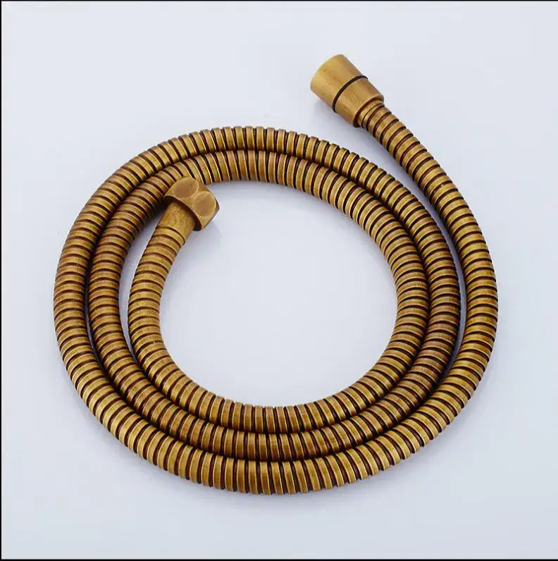 Gold-colored ribbed stainless steel flexible shower hose with brass fittings for bathroom use