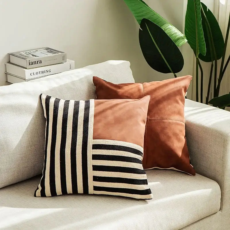 A stylish black stripe faux leather pillow cover with cream stripes and burnt orange suede for living room decorbites decor