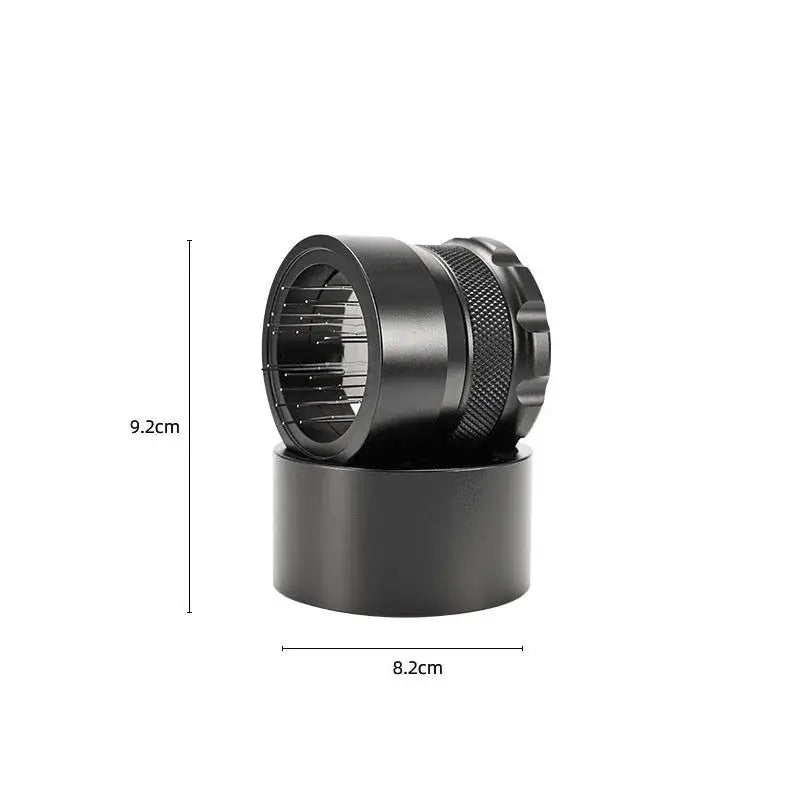 Black metal herb grinder with textured grip and internal chamber for decorbites coffee needle block distributor use