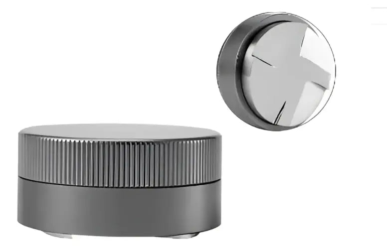 Silver metallic herb grinder with ribbed cylindrical body and x-shaped top cap paired with decorbites espresso tamper