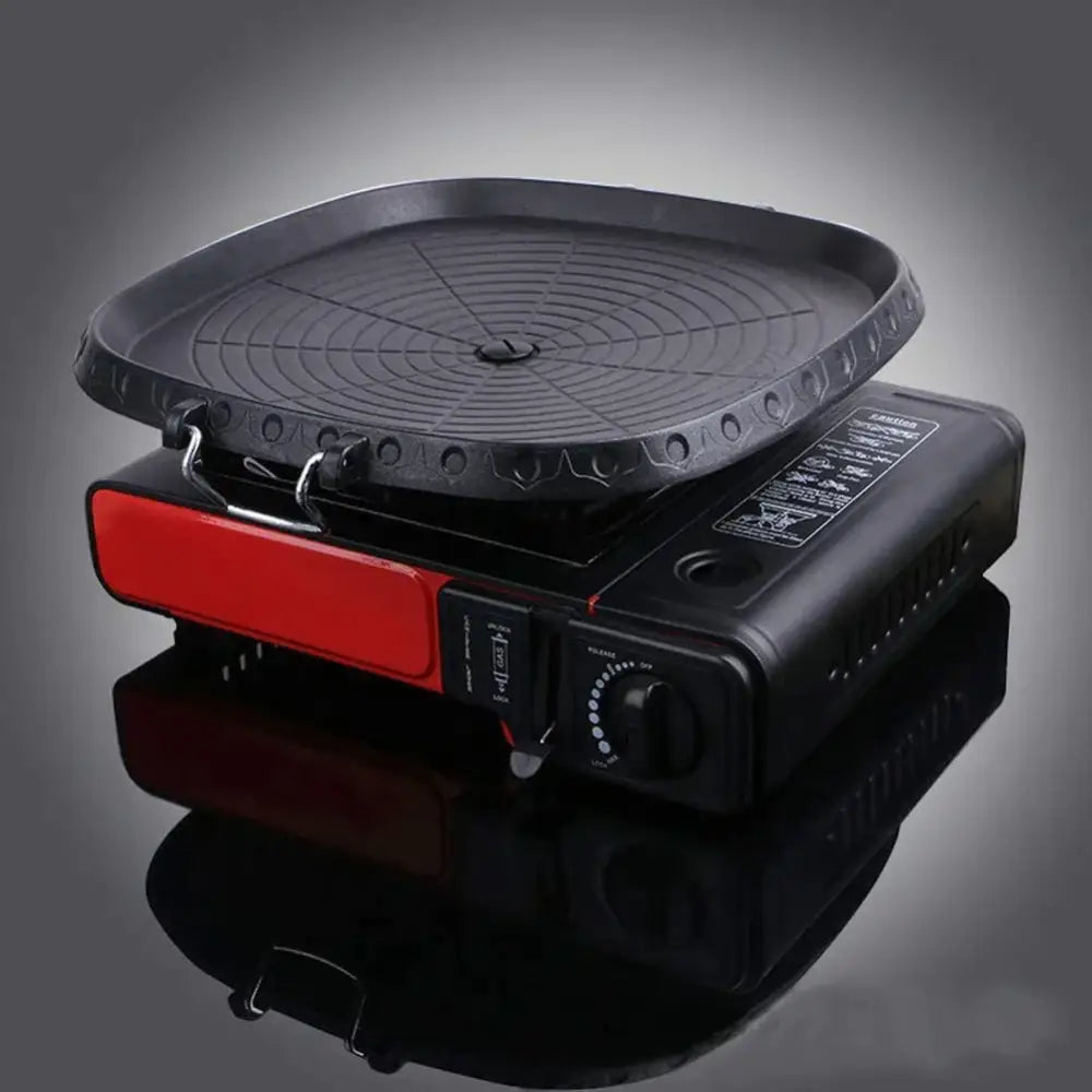 Black textured square korean bbq grill pan with red side panel and circular grilling surface for kitchen cookware