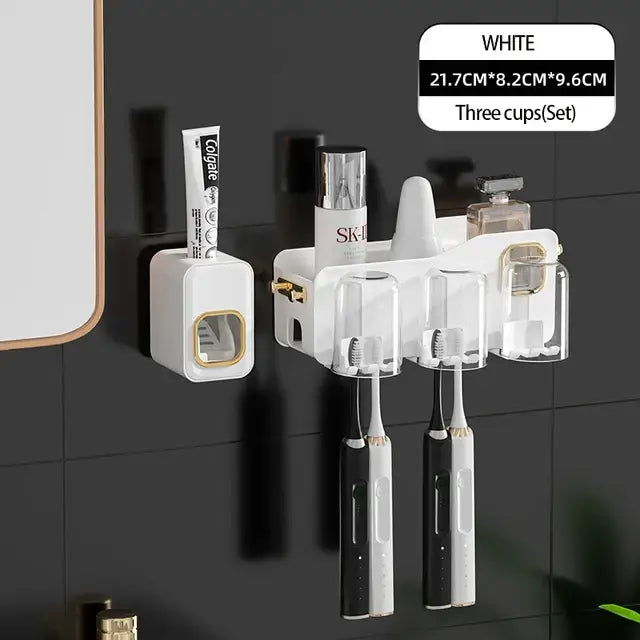 White toothbrush holder with clear cups and gold accents designed for three electric toothbrushes in decorbites inverted toothbrush holder
